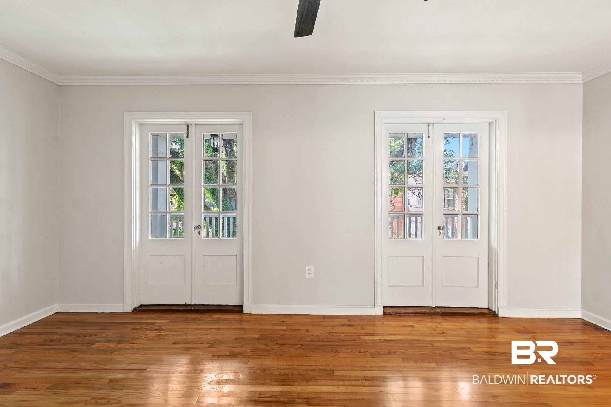 214 Upham Street, Unit 8D Mobile, AL 36607 - Photo 7 of 36 Entryway featuring french doors, hardwood / wood-style floors, ceiling fan, and ornamental molding