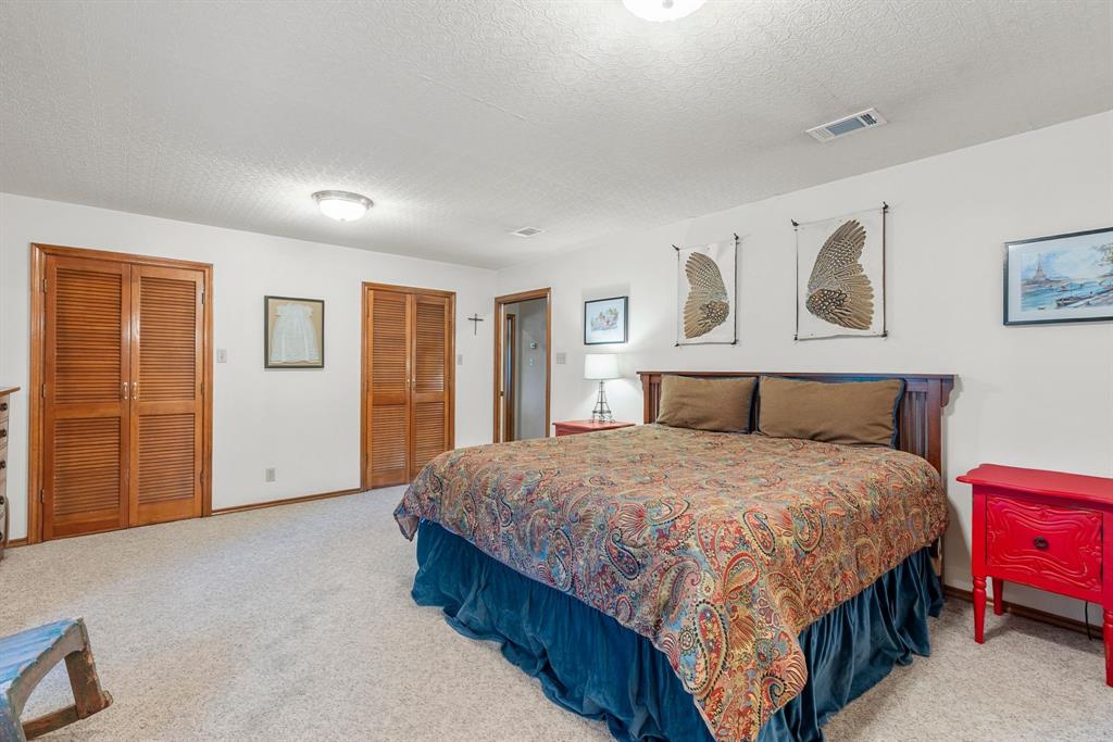 476 Private Road 7326 Emory, TX 75440 - Photo 25 of 33 a bedroom with a large bed and a chandelier