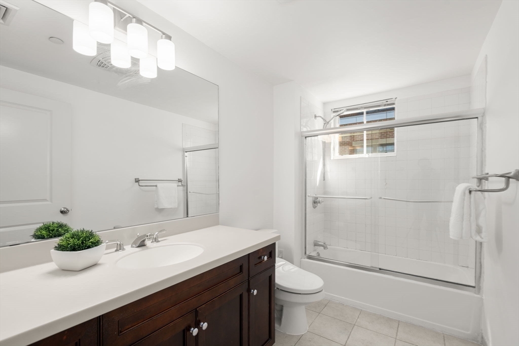 125 Crowninshield Road, Unit 125 Brookline, MA 02446 - Photo 18 of 21 a bathroom with a sink a toilet and shower
