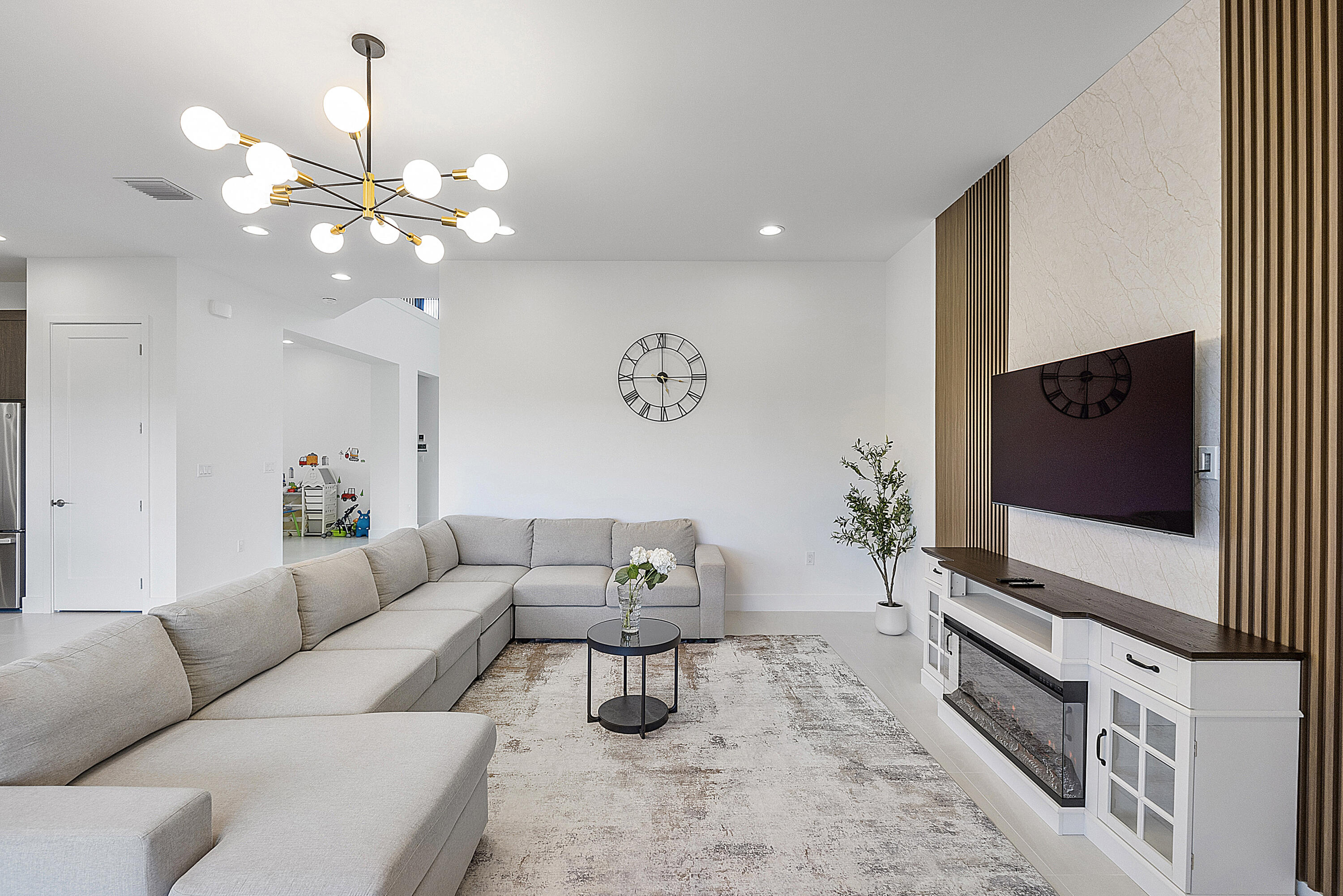 20296 Somerset Hls Drive Boca Raton, FL 33434 - Photo 11 of 67 a living room with furniture chandelier and a flat screen tv