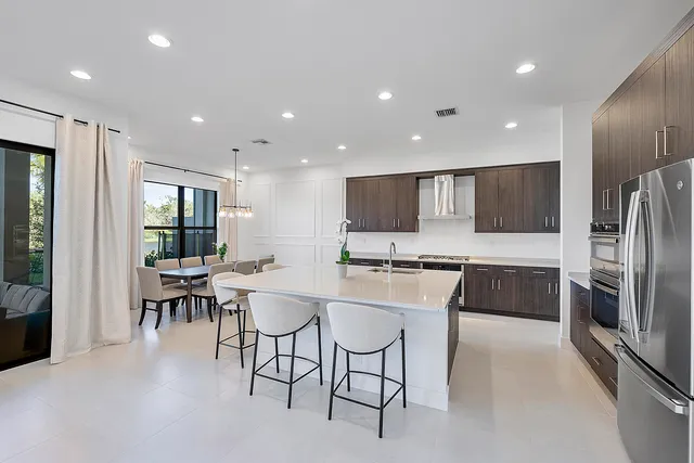 a bathroom with a granite countertop sink a toilet and a large mirror