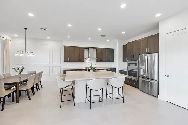 a living room with furniture large windows and a flat screen tv