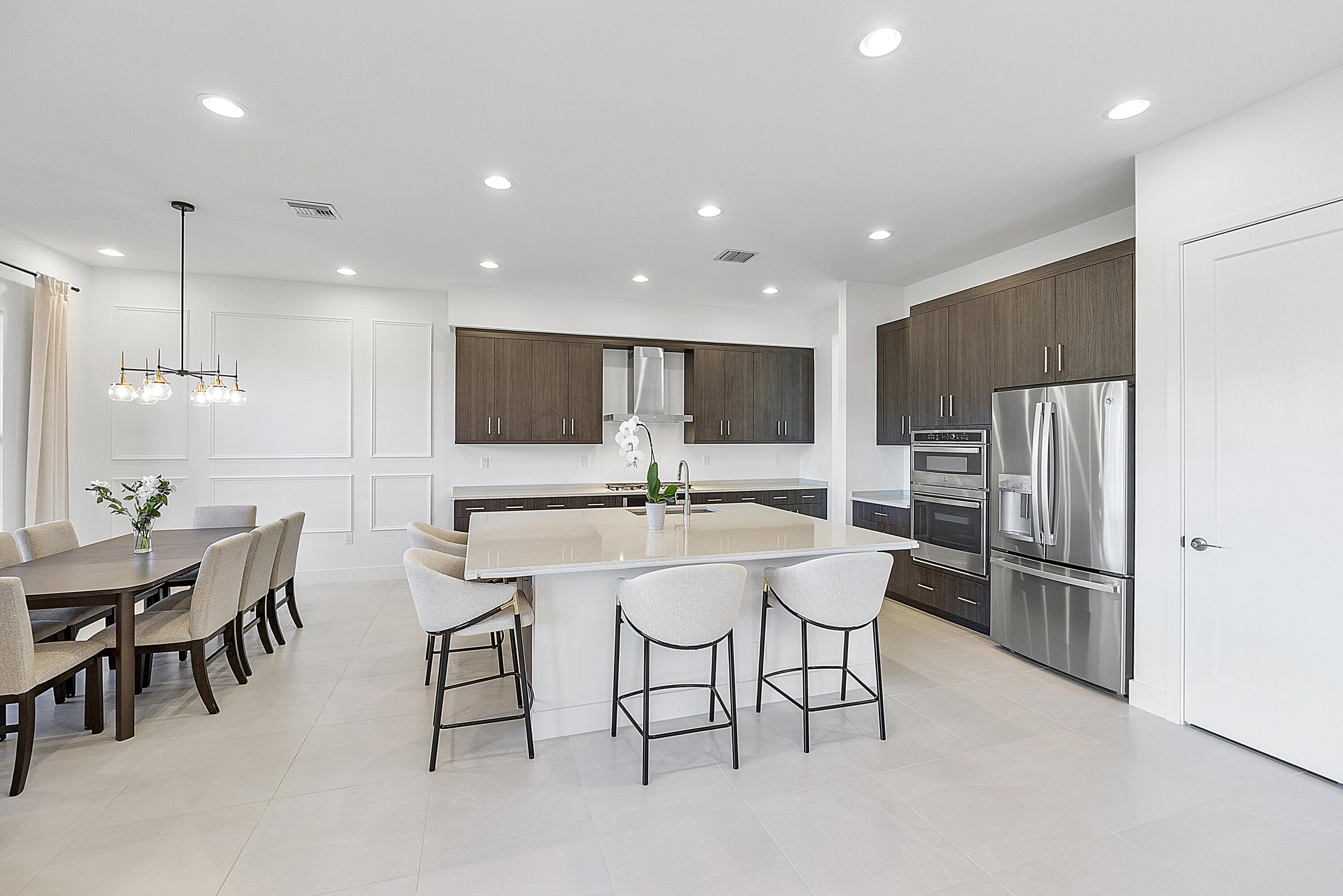 20296 Somerset Hls Drive Boca Raton, FL 33434 - Photo 13 of 67 a kitchen with stainless steel appliances a dining table chairs and refrigerator