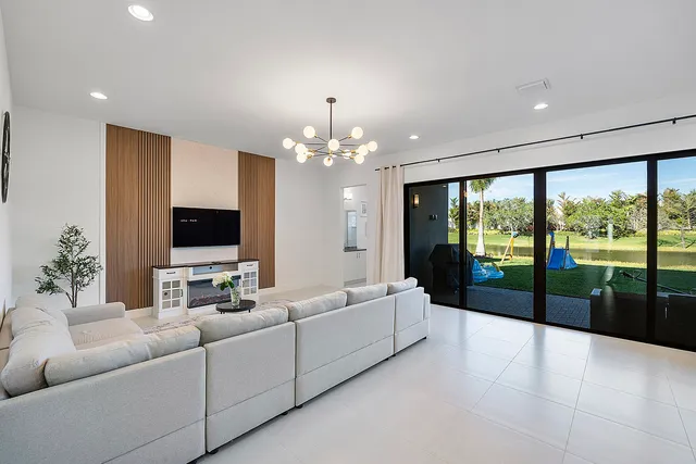 a living room with furniture and a chandelier