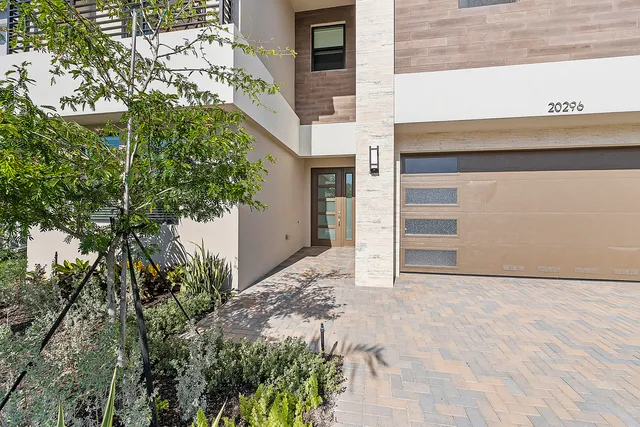a view of a hallway with wooden floor and a living room