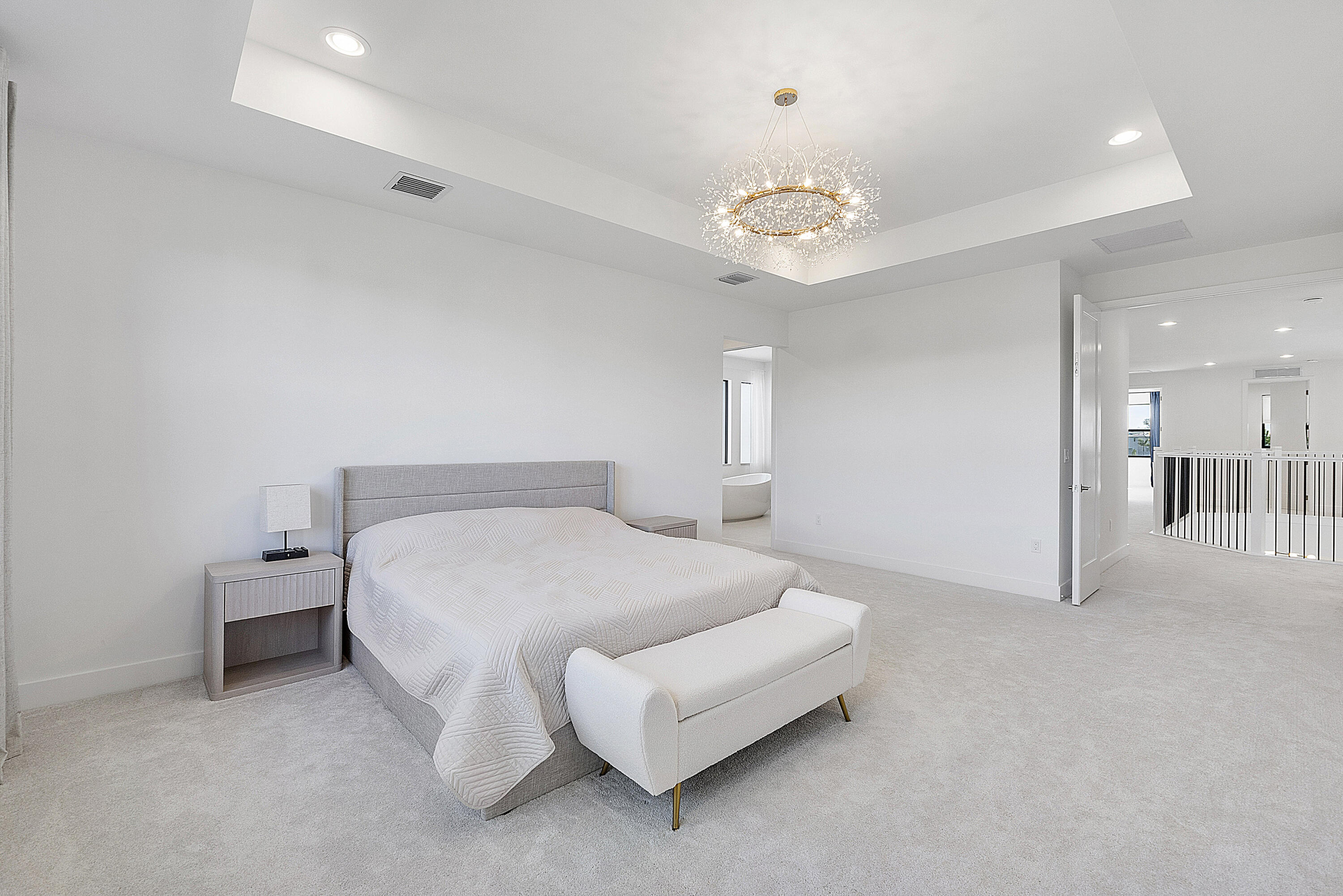 20296 Somerset Hls Drive Boca Raton, FL 33434 - Photo 32 of 67 a spacious bedroom with a bed and a chandelier