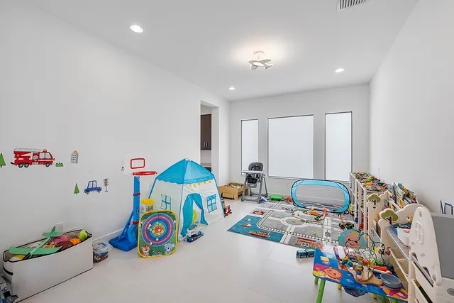 a lobby with furniture and large windows