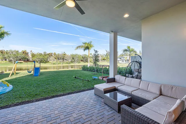 a living room with furniture and a pool table