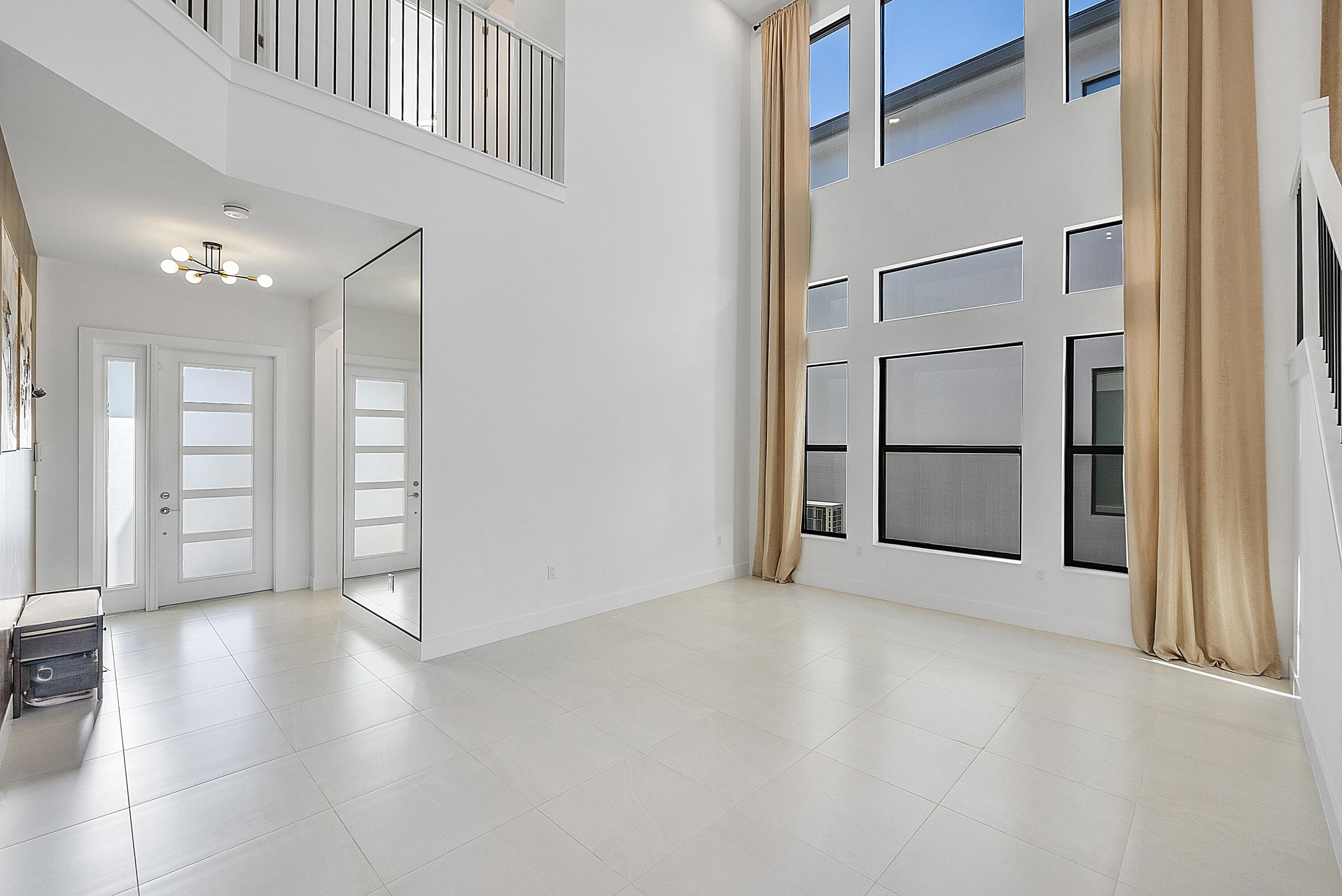 20296 Somerset Hls Drive Boca Raton, FL 33434 - Photo 7 of 67 an empty room with windows and pillars in it