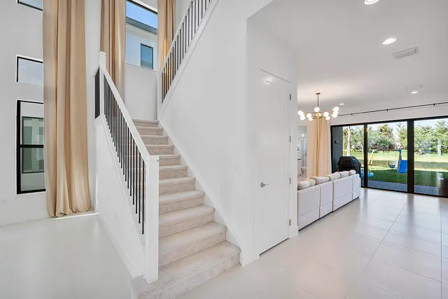 a kitchen with stainless steel appliances refrigerator dining table and chairs