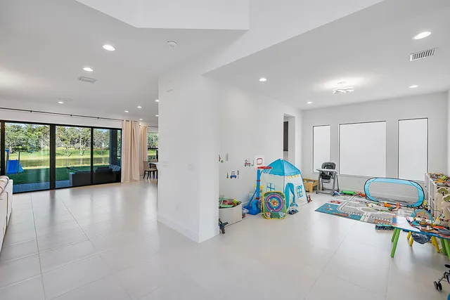 a living room with furniture and view of kitchen