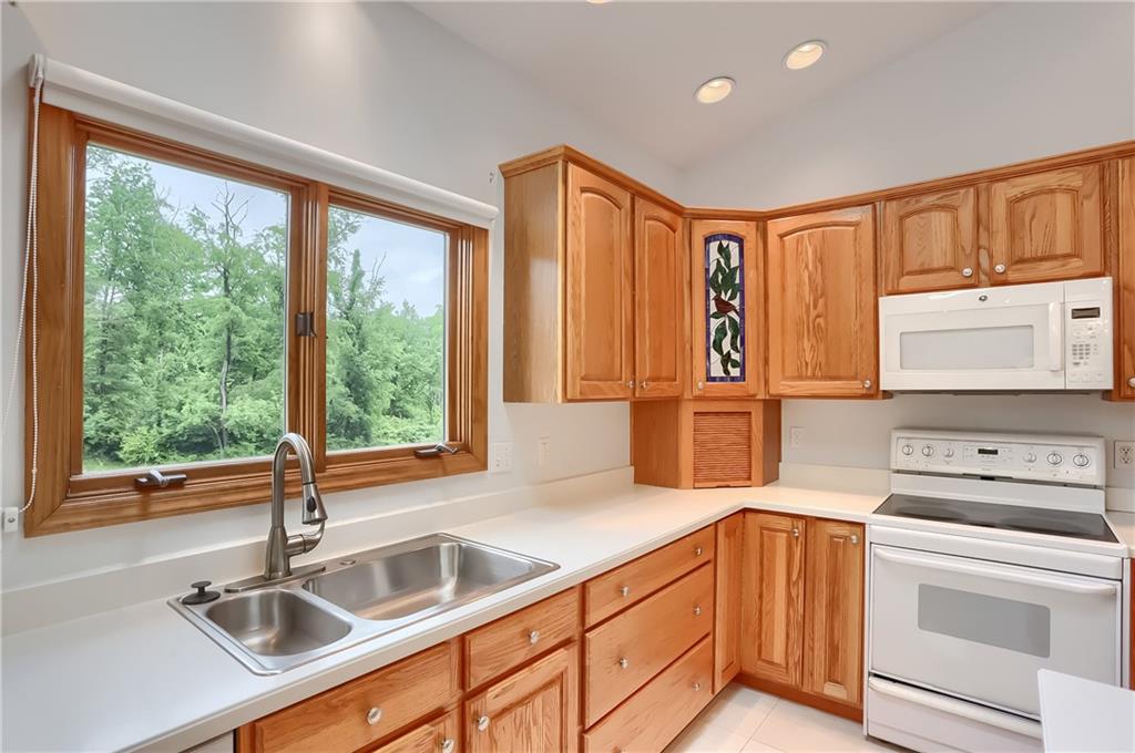 377 Magee Road Sewickley, PA 15143 - Photo 16 of 50 a kitchen with stainless steel appliances granite countertop a sink and a refrigerator