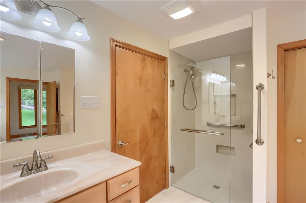 377 Magee Road Sewickley, PA 15143 - Photo 24 of 50 a bathroom with a granite countertop sink shower and a mirror
