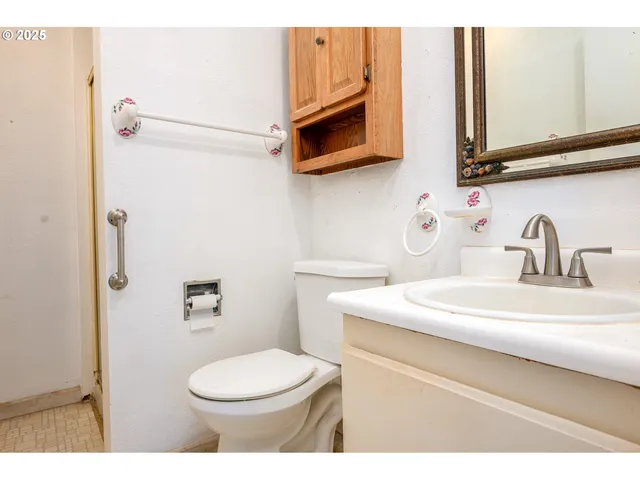 a bathroom with a sink a toilet and mirror