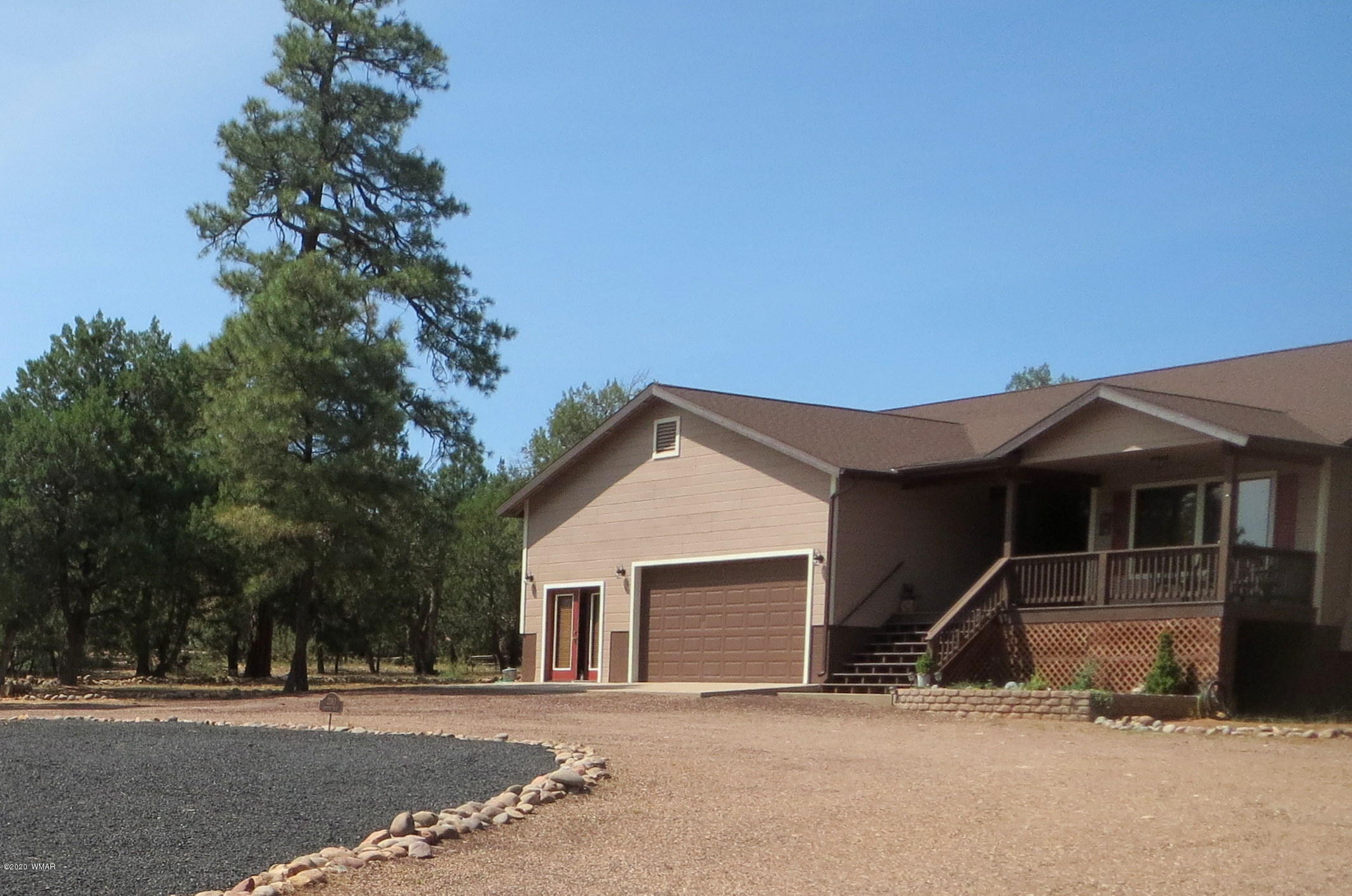 2190 Rimview Trail Overgaard, AZ 85933 - Photo 2 of 45 a front view of a house with a garden