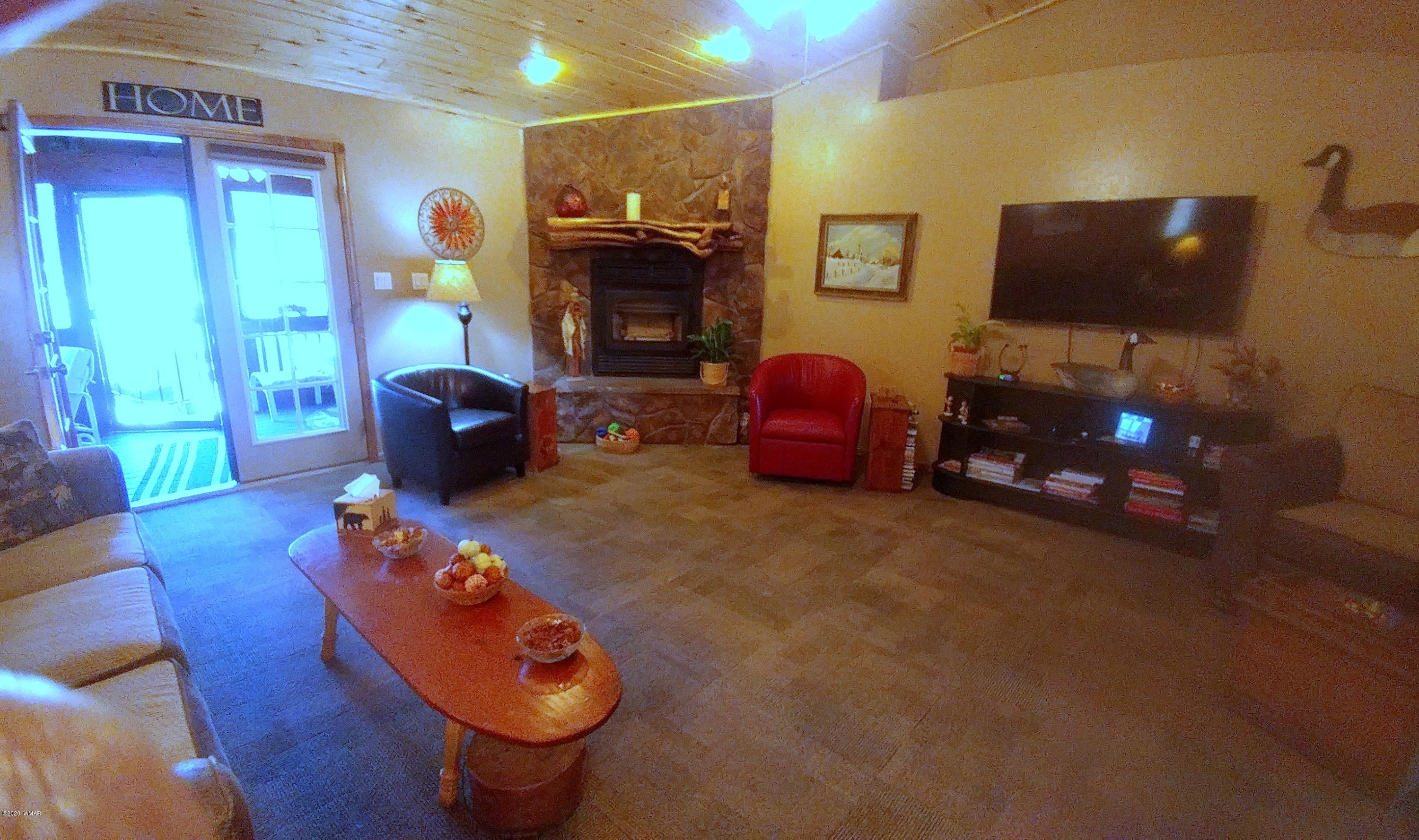 2190 Rimview Trail Overgaard, AZ 85933 - Photo 8 of 45 a living room with furniture and a flat screen tv