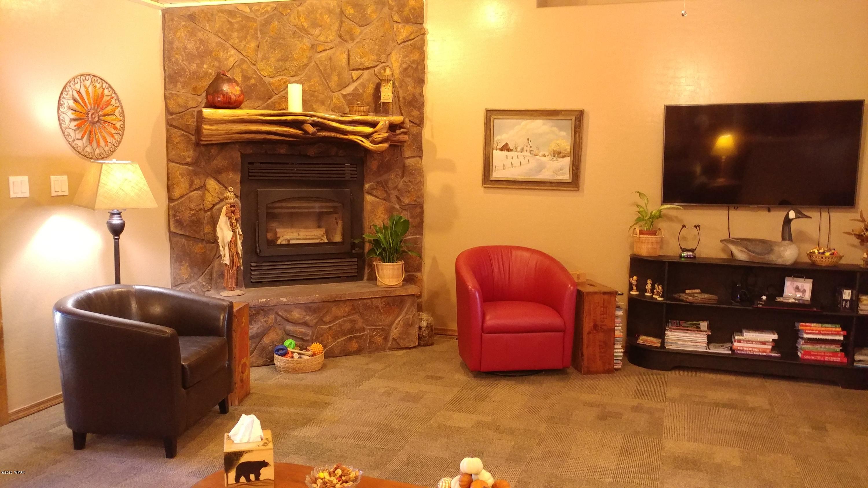 2190 Rimview Trail Overgaard, AZ 85933 - Photo 9 of 45 a living room with furniture and a flat screen tv