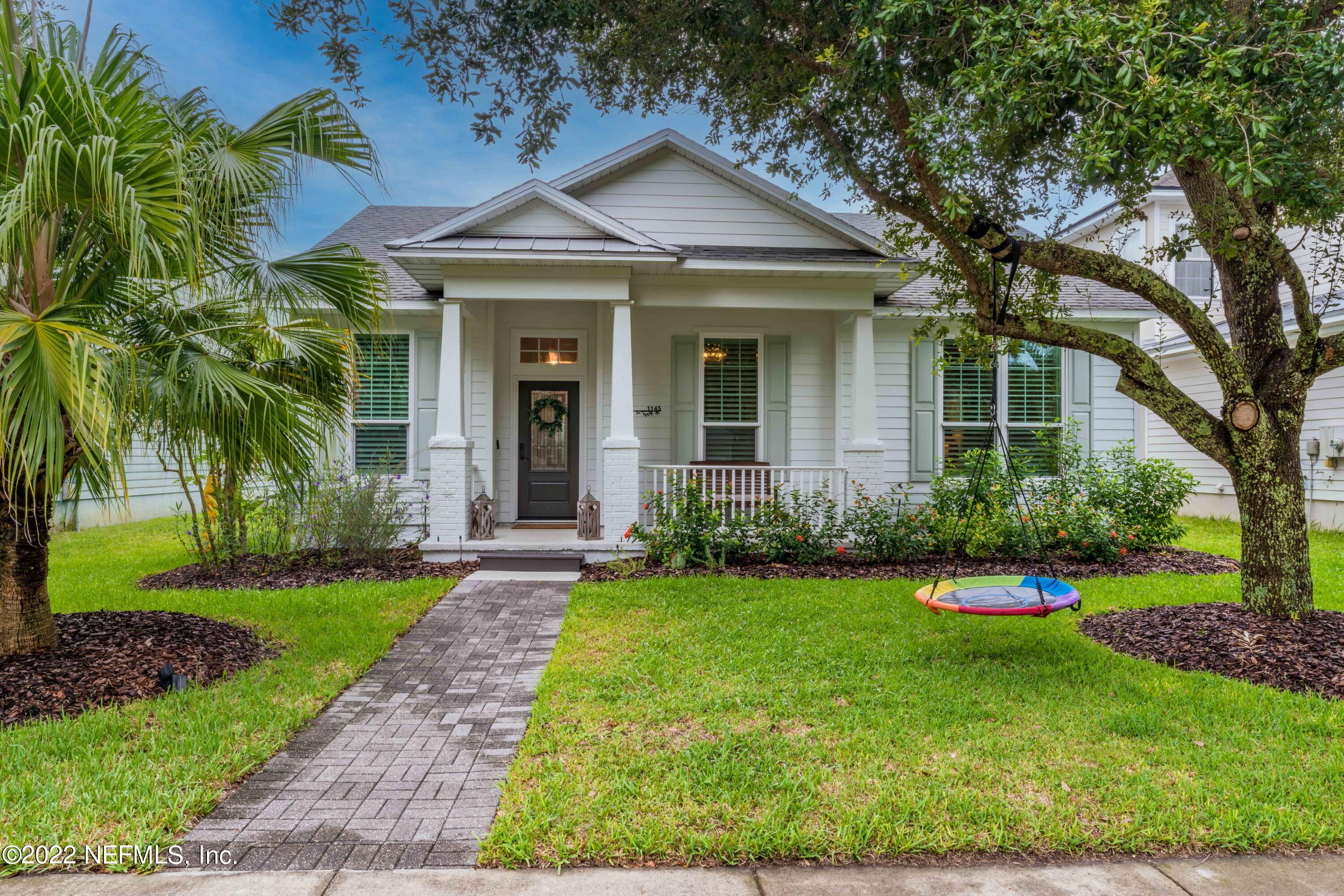 1145 Overdale Road St. Augustine, FL 32080 - Photo 1 of 85 a front view of a house with a yard and potted plants