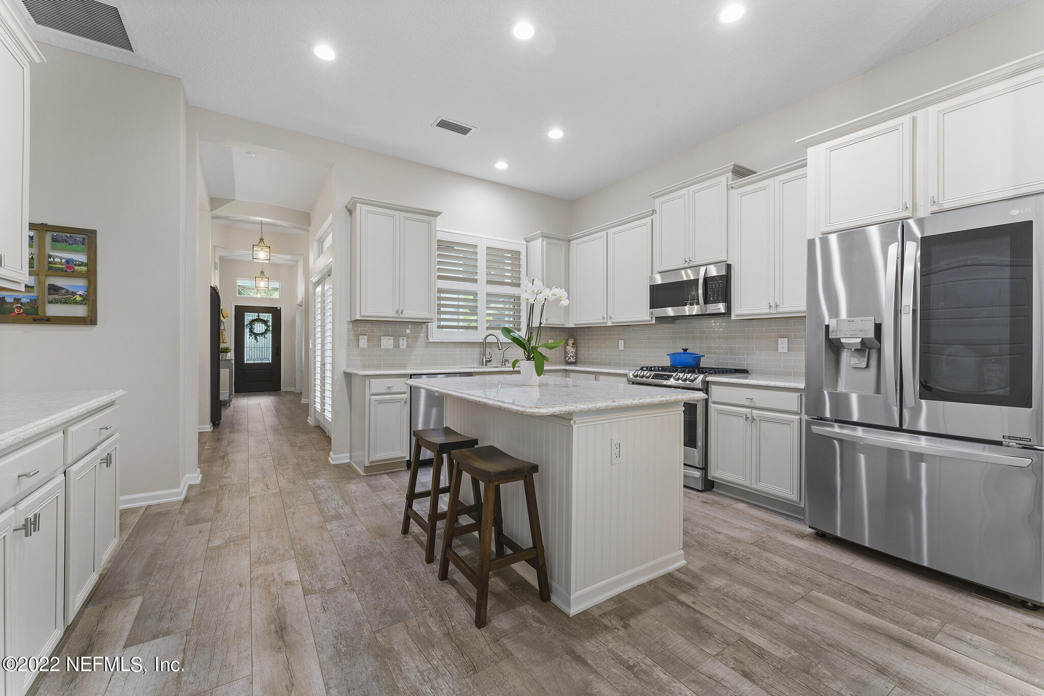 1145 Overdale Road St. Augustine, FL 32080 - Photo 19 of 85 a kitchen with white cabinets and stainless steel appliances