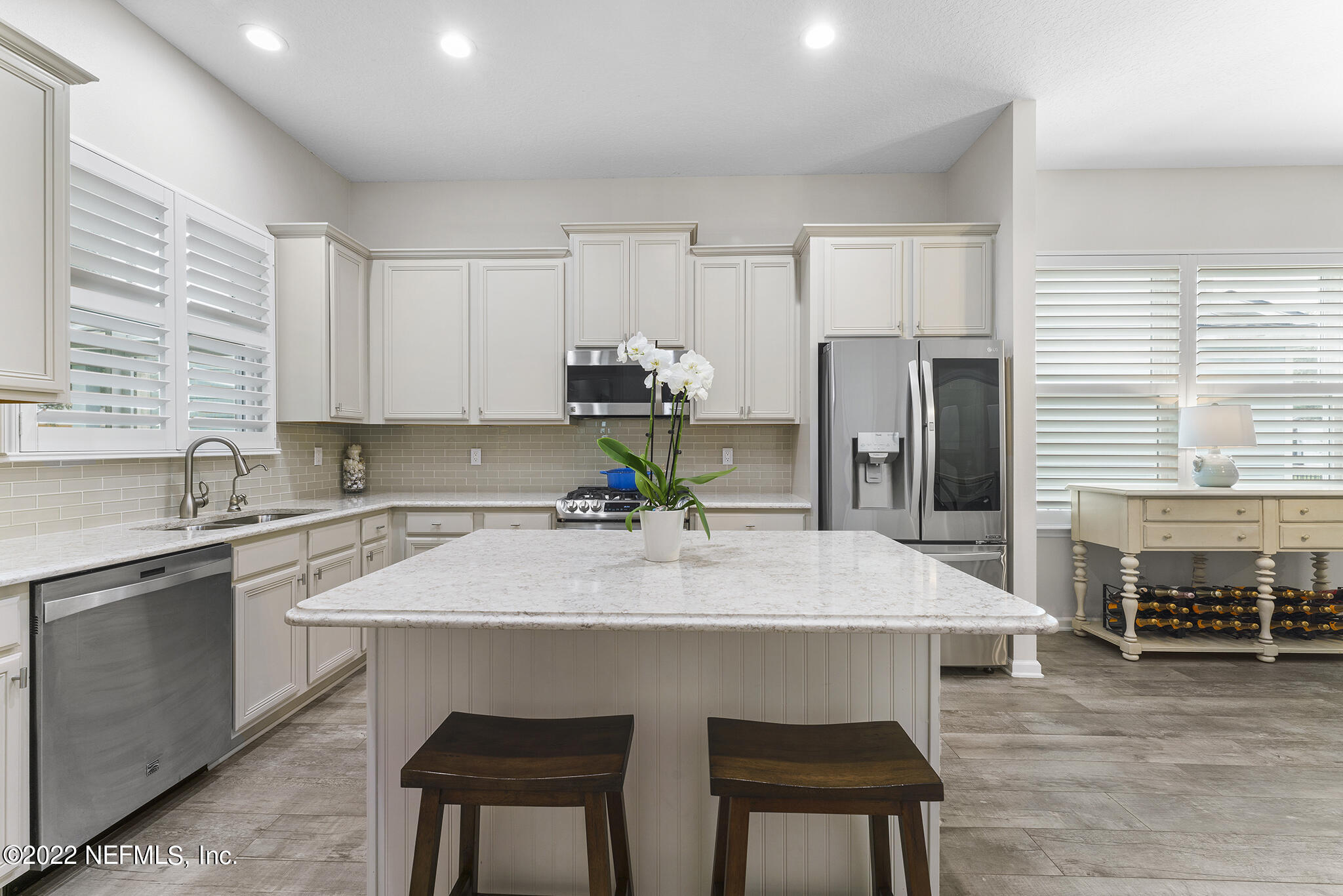1145 Overdale Road St. Augustine, FL 32080 - Photo 20 of 85 a kitchen with kitchen island a sink stove and refrigerator