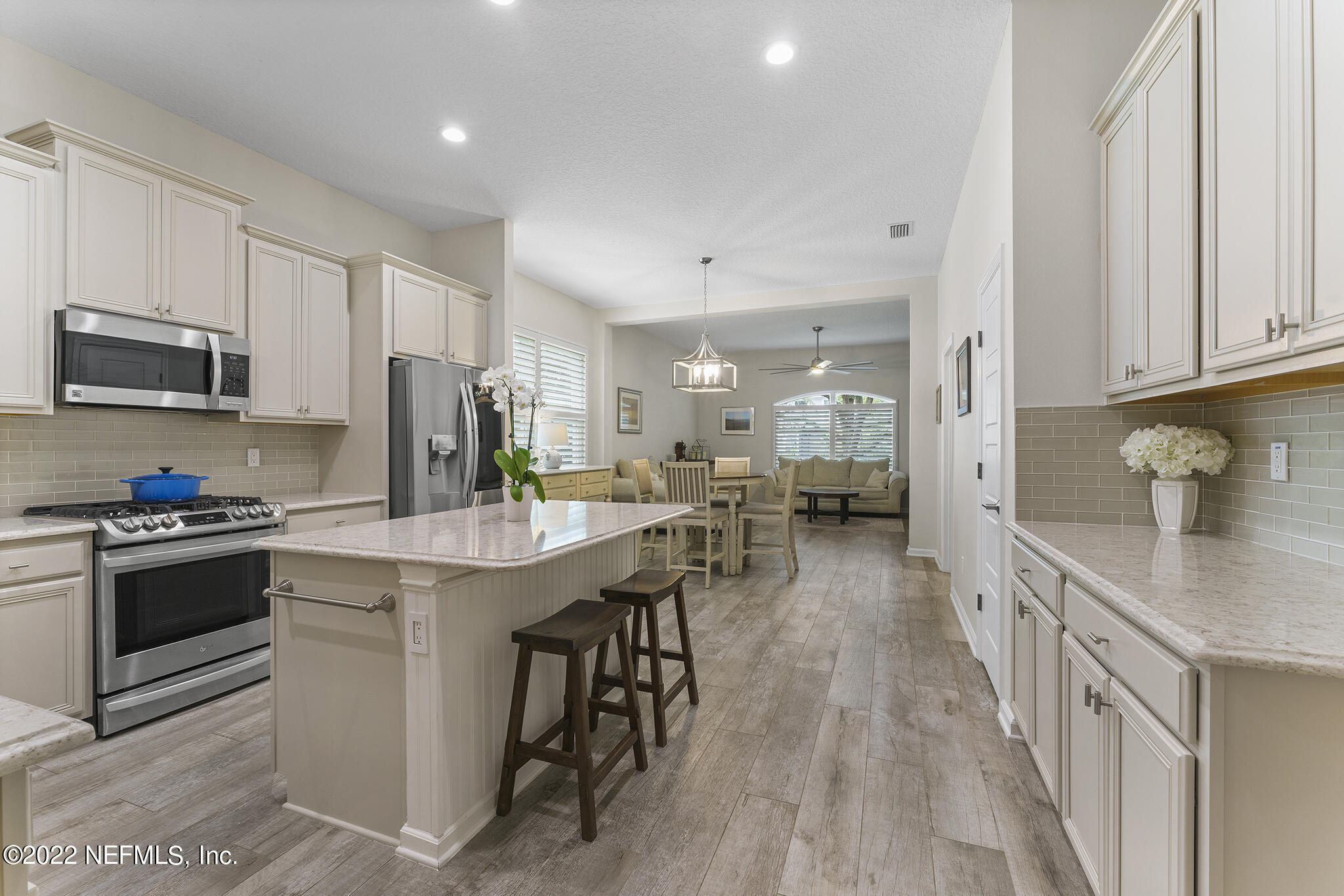 1145 Overdale Road St. Augustine, FL 32080 - Photo 21 of 85 a kitchen with stainless steel appliances granite countertop a stove top oven a sink dishwasher and a refrigerator with wooden floor