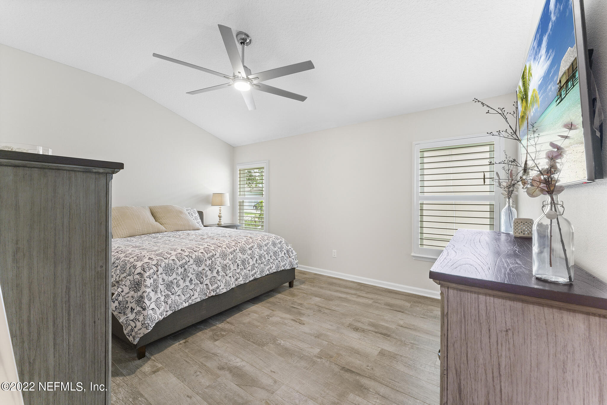 1145 Overdale Road St. Augustine, FL 32080 - Photo 30 of 85 a bedroom with a bed and a chandelier