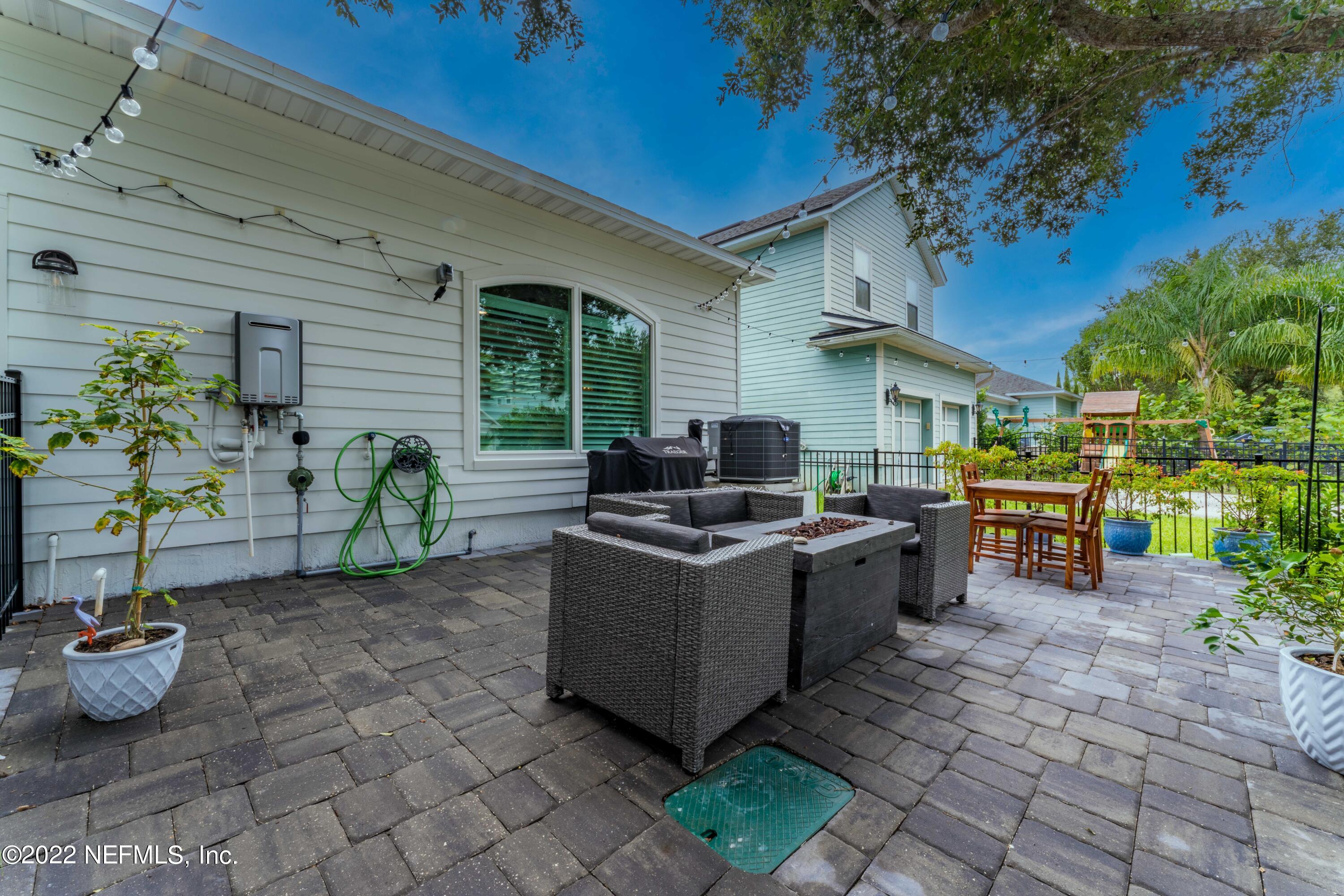 1145 Overdale Road St. Augustine, FL 32080 - Photo 51 of 85 a view of a patio with chairs and potted plants