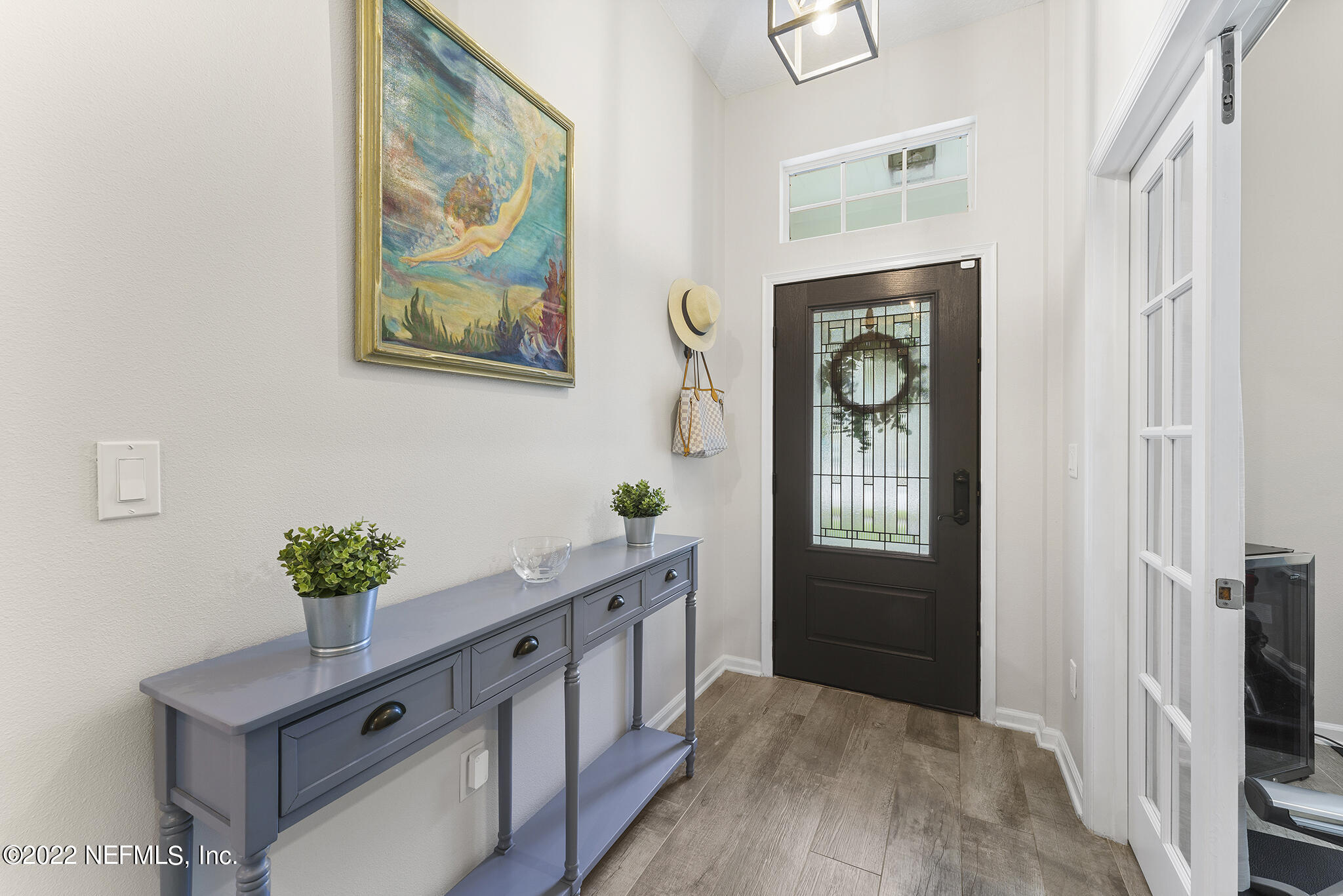 1145 Overdale Road St. Augustine, FL 32080 - Photo 10 of 85 a hallway with painting on the wall and a potted plant