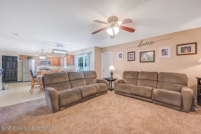 a living room with furniture a lamp and a window