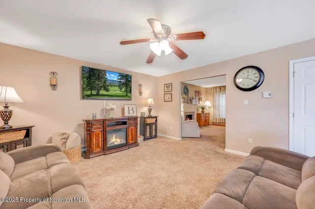 a dining room with furniture a chandelier and wooden floor