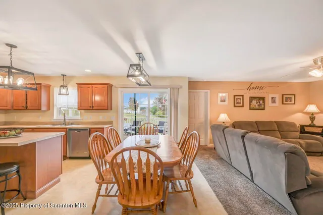 a large kitchen with stainless steel appliances granite countertop a large stove a sink dishwasher and a refrigerator with wooden floor