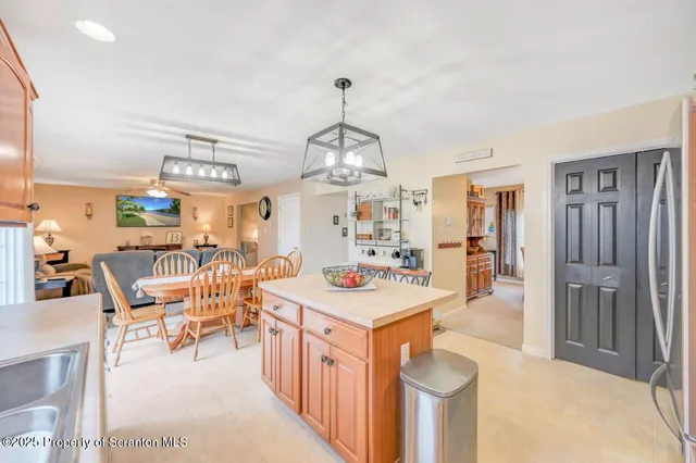 a dining room with furniture and chandelier