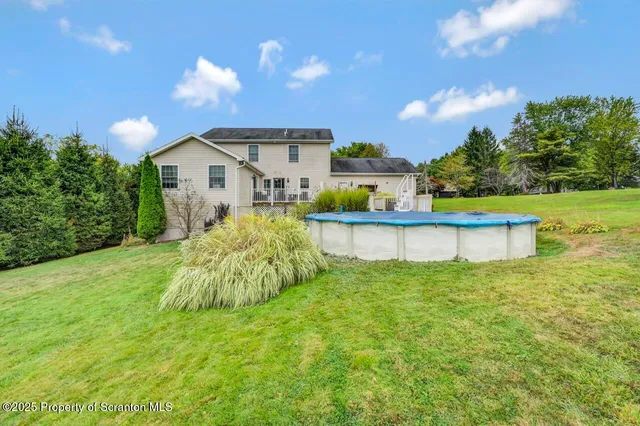 a view of a house with a yard and a garden
