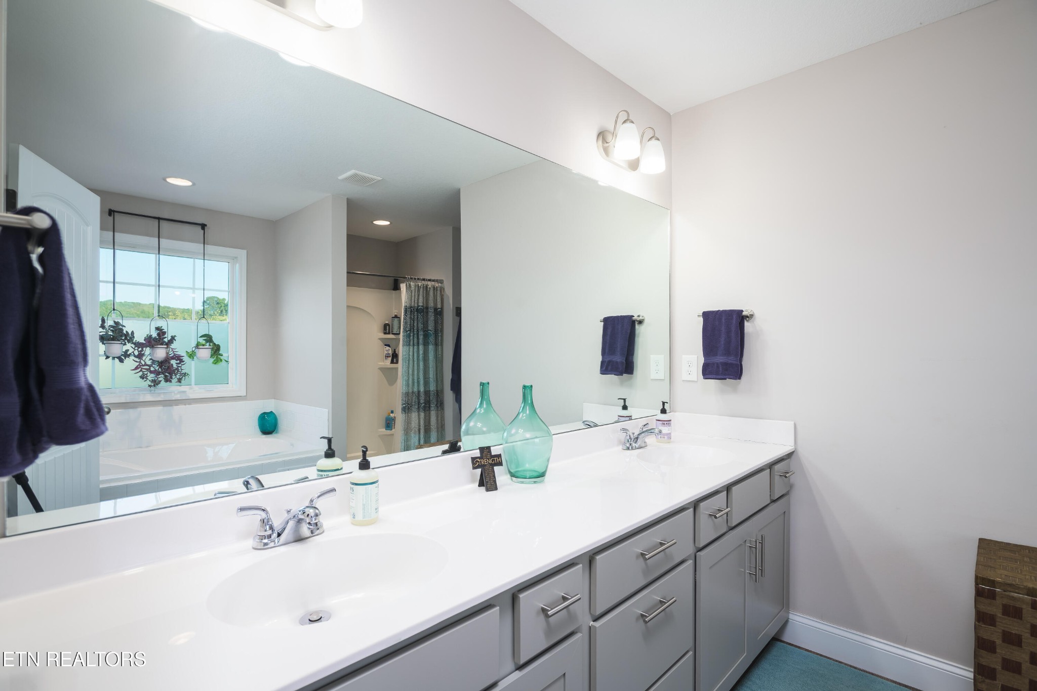 8232 Zodiac Lane Powell, TN 37849 - Photo 18 of 22 a bathroom with a double vanity sink and a mirror
