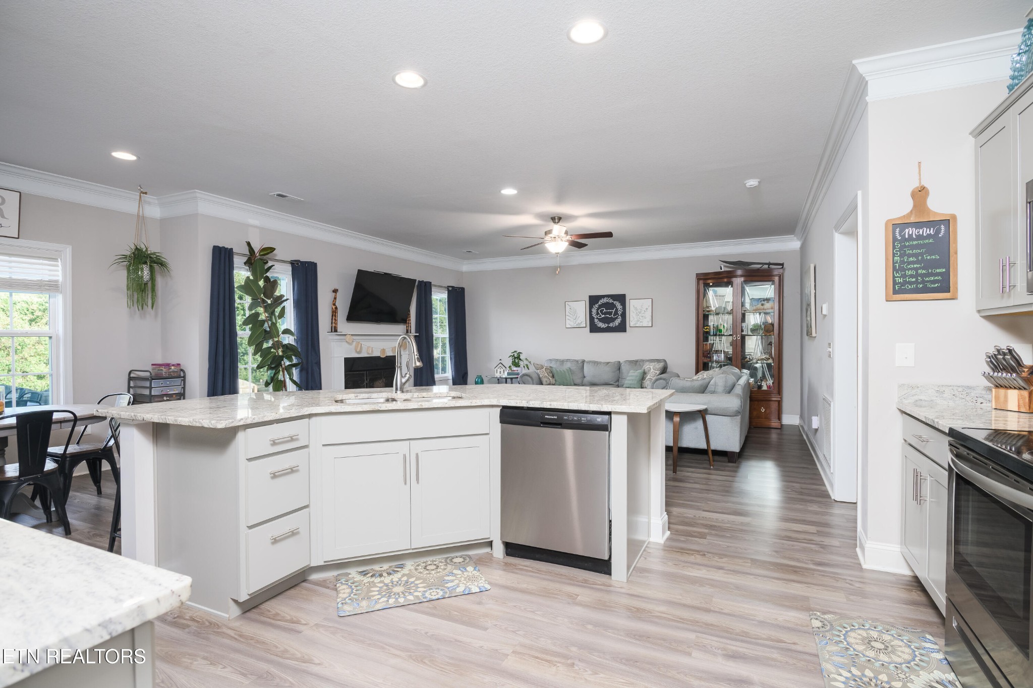 8232 Zodiac Lane Powell, TN 37849 - Photo 6 of 22 a large white kitchen with cabinets a sink and appliances