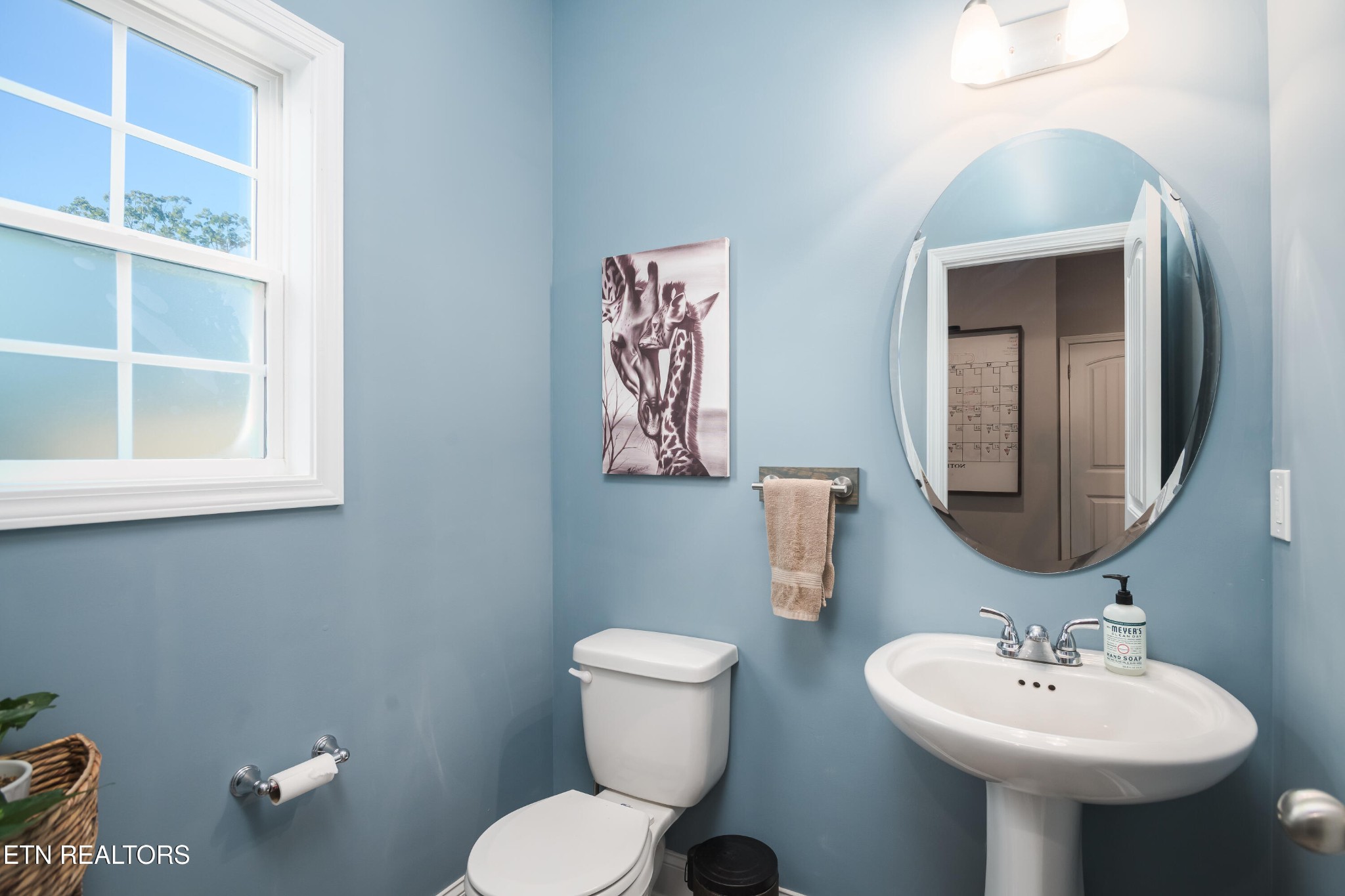 8232 Zodiac Lane Powell, TN 37849 - Photo 10 of 22 a bathroom with a toilet sink and mirror