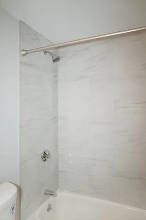 a bathroom with a shower and a toilet