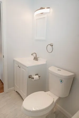 a white toilet sitting next to a bathroom sink