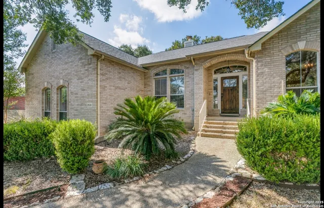 a front view of a house with garden