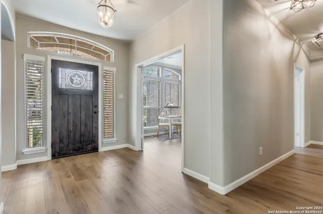 a view of empty room with wooden floor