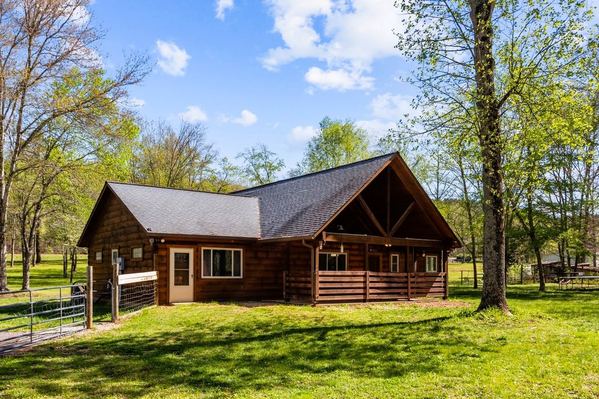 13631 Birdsong Road Holladay, TN 38341 - Photo 12 of 67 a front view of house with yard and trees in the background
