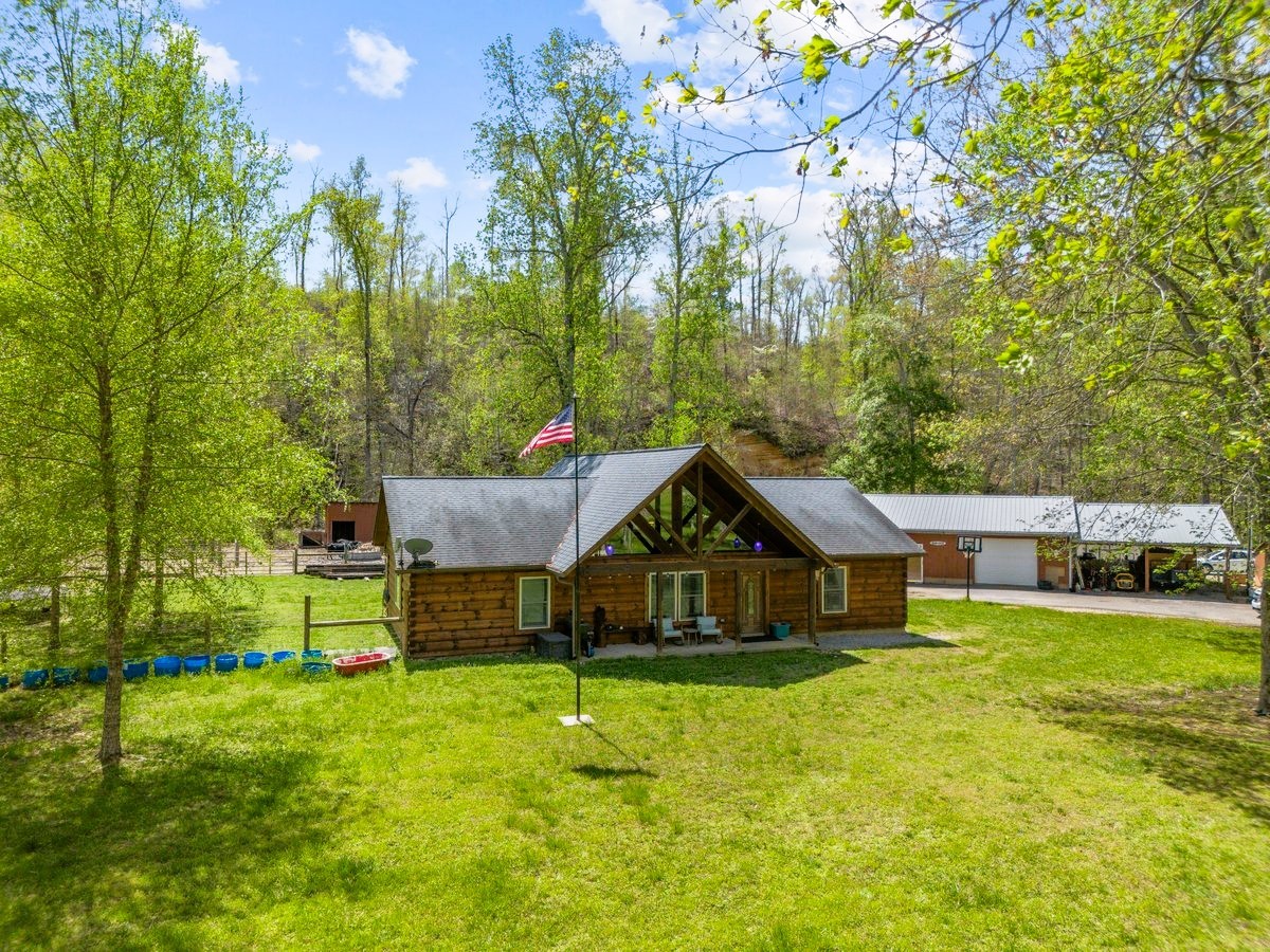 13631 Birdsong Road Holladay, TN 38341 - Photo 14 of 67 a front view of a house with garden