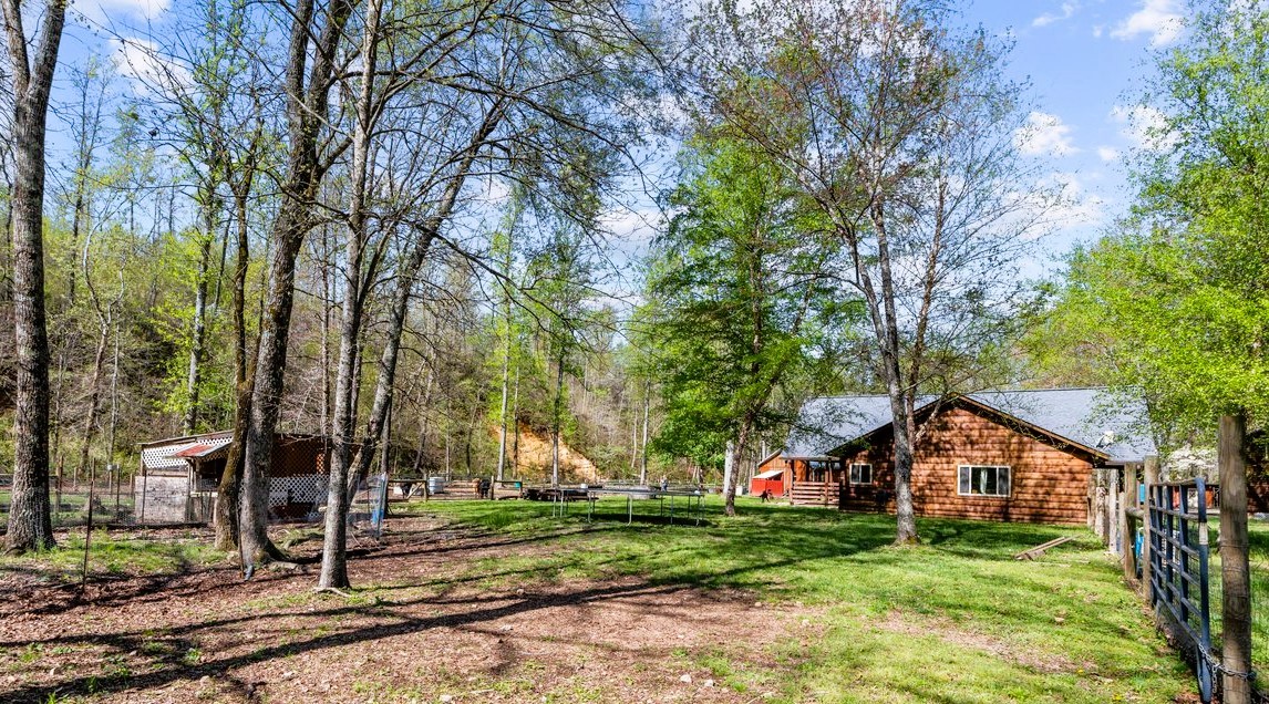 13631 Birdsong Road Holladay, TN 38341 - Photo 15 of 67 a front view of a house with garden