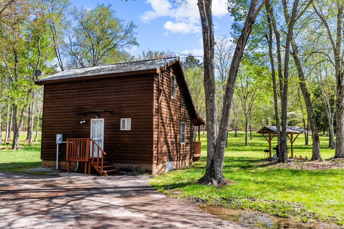 13631 Birdsong Road Holladay, TN 38341 - Photo 17 of 67 a front view of a house with garden