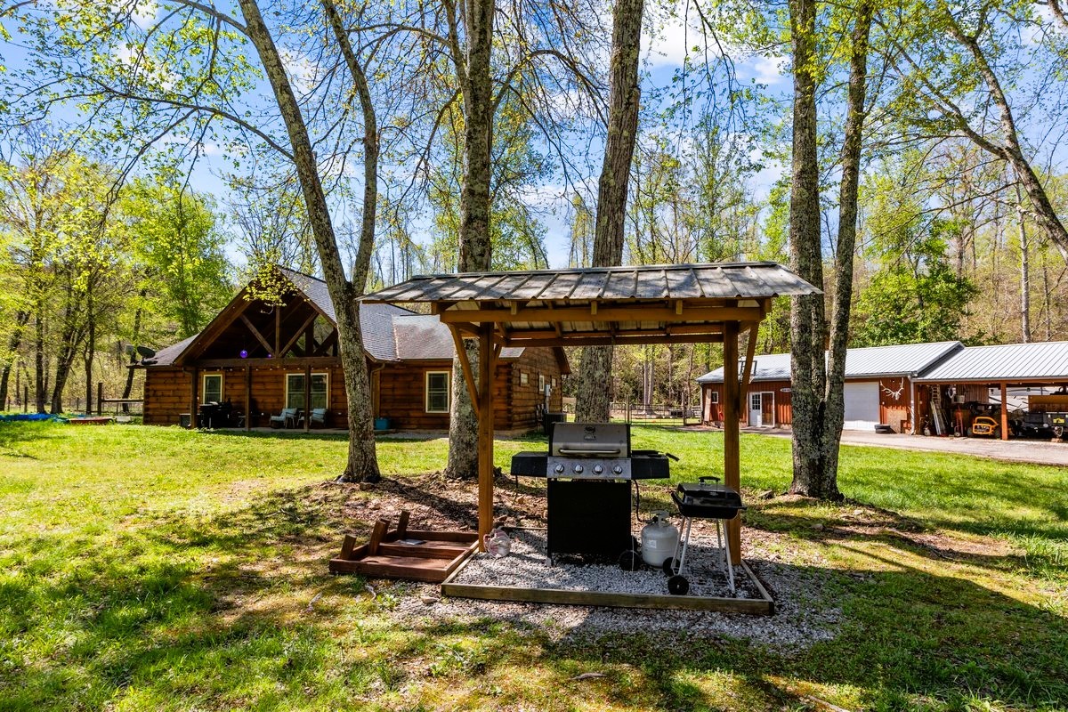13631 Birdsong Road Holladay, TN 38341 - Photo 18 of 67 a view of a house with backyard porch and sitting area