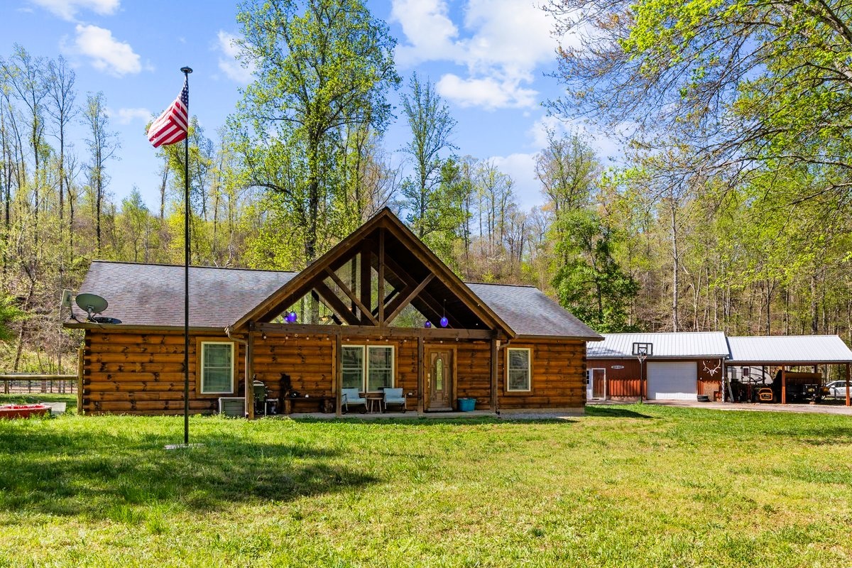 13631 Birdsong Road Holladay, TN 38341 - Photo 20 of 67 a front view of a house with a yard and potted plants
