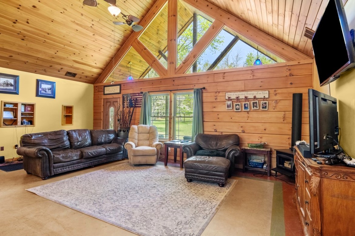 13631 Birdsong Road Holladay, TN 38341 - Photo 21 of 67 a living room with furniture a flat screen tv and a fireplace