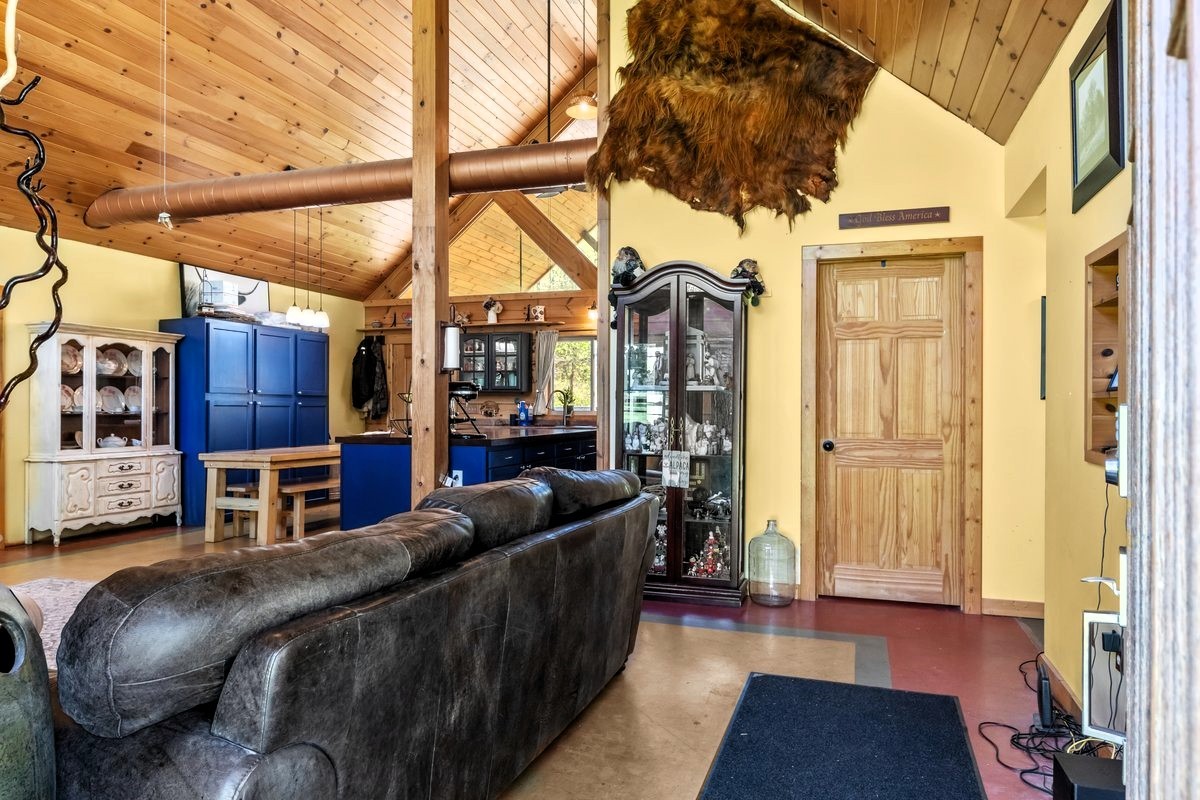 13631 Birdsong Road Holladay, TN 38341 - Photo 23 of 67 a living room with furniture and a fireplace