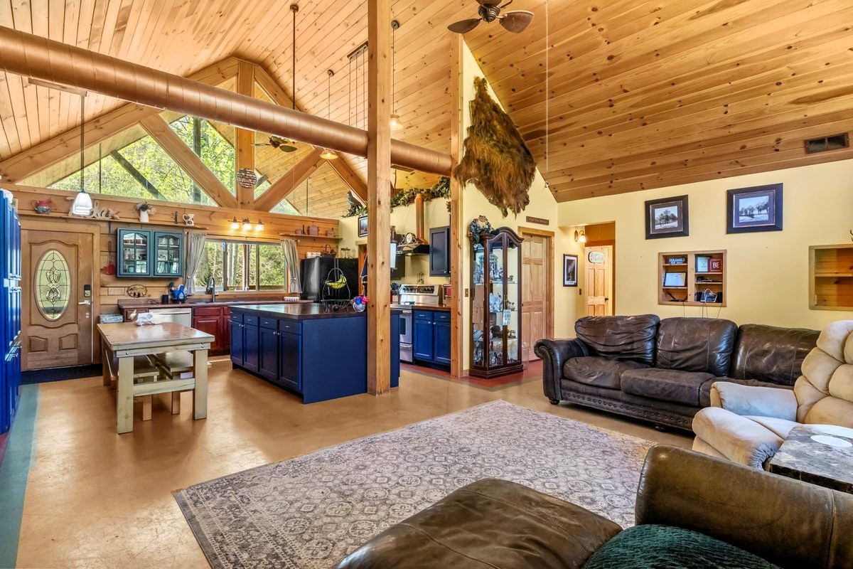 13631 Birdsong Road Holladay, TN 38341 - Photo 24 of 67 a living room with furniture a couch and large windows