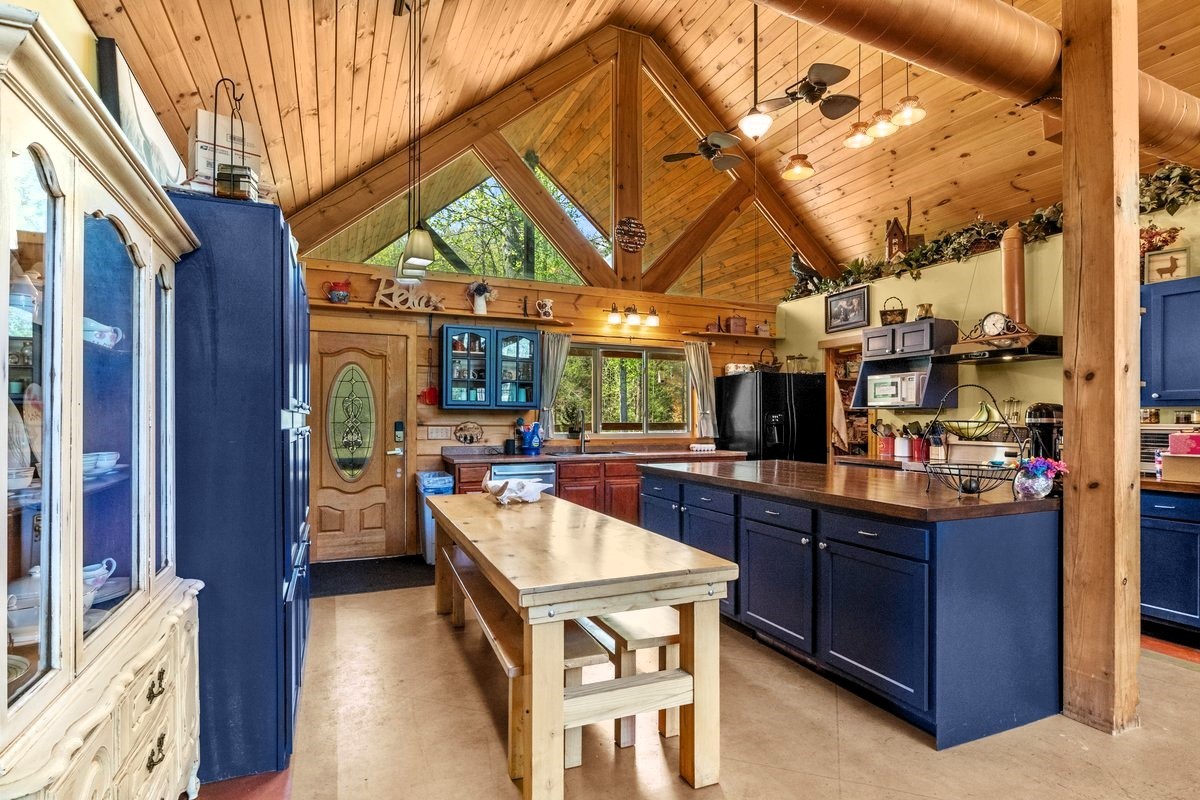 13631 Birdsong Road Holladay, TN 38341 - Photo 25 of 67 a kitchen filled with stainless steel appliances granite countertop a sink and cabinets
